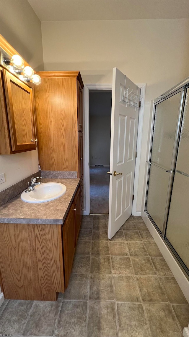 bathroom featuring walk in shower and vanity