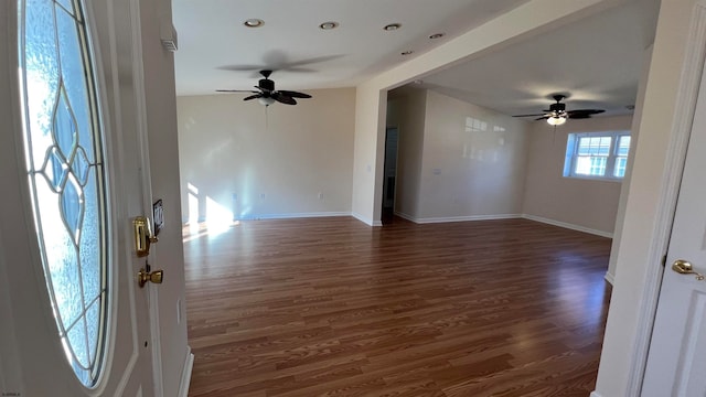 spare room featuring dark wood-type flooring and ceiling fan