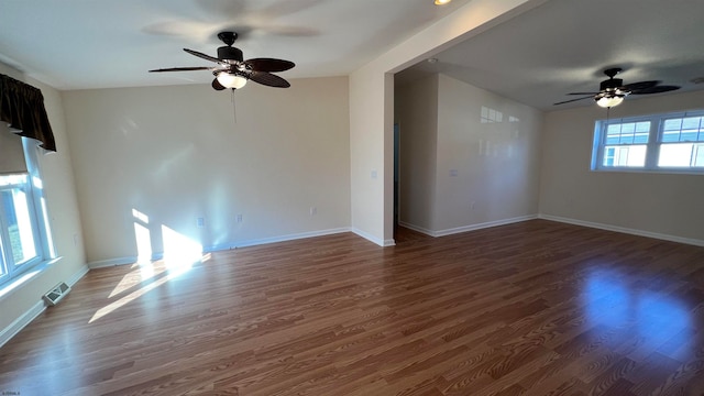 unfurnished room featuring dark wood-type flooring, vaulted ceiling, and ceiling fan