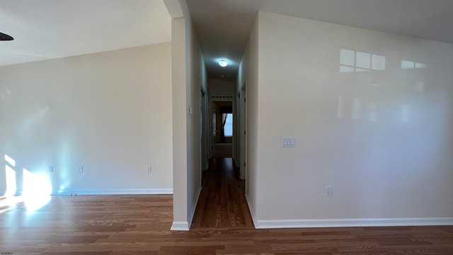 unfurnished room with lofted ceiling and dark hardwood / wood-style floors