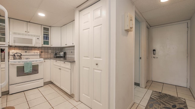 4540 W Brigantine Ave Unit N-102, Brigantine, NJ 08203 - kitchen with white appliances, light tile patterned flooring, a paneled ceiling, white cabinets, and recessed lighting