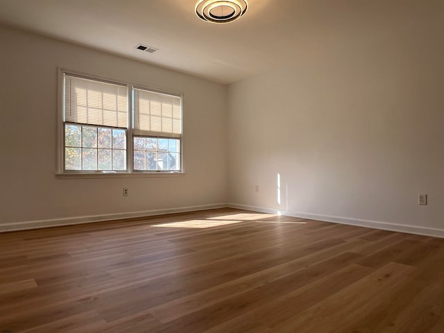 spare room with dark hardwood / wood-style flooring