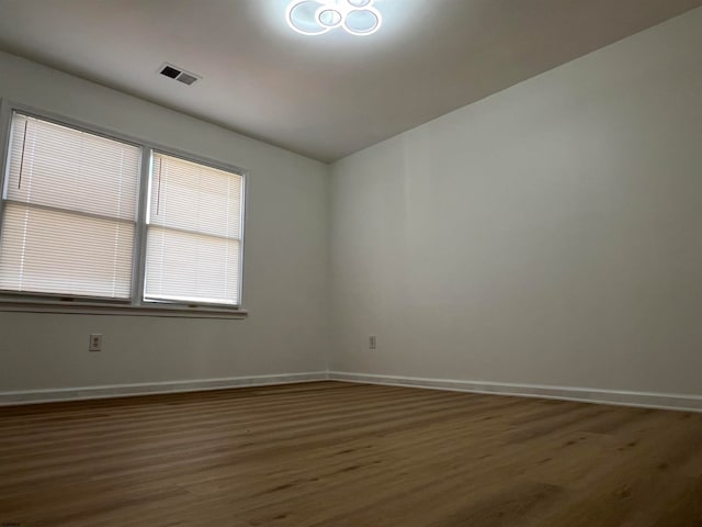 unfurnished room featuring dark wood-type flooring