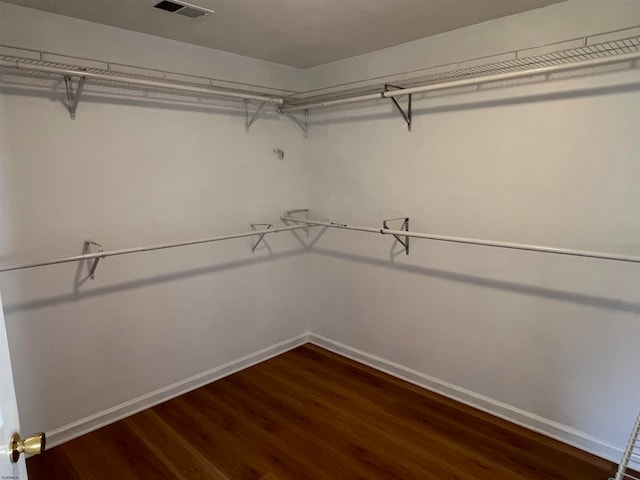 walk in closet featuring dark hardwood / wood-style floors