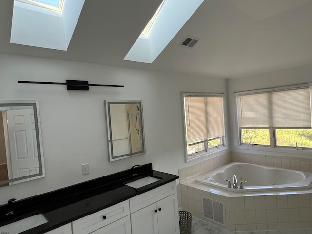 bathroom featuring vanity, tiled bath, and lofted ceiling