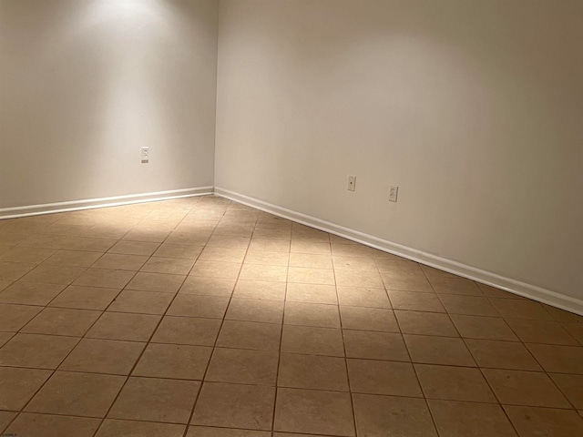 unfurnished room with tile patterned flooring