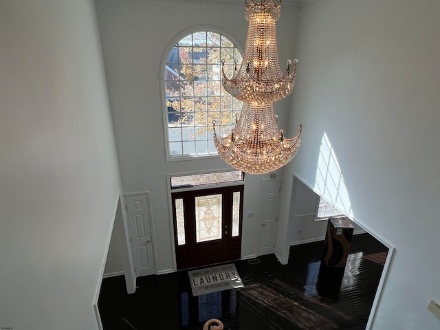 foyer entrance featuring a notable chandelier