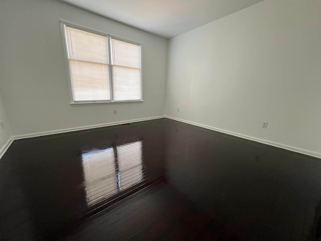 unfurnished room featuring dark hardwood / wood-style floors