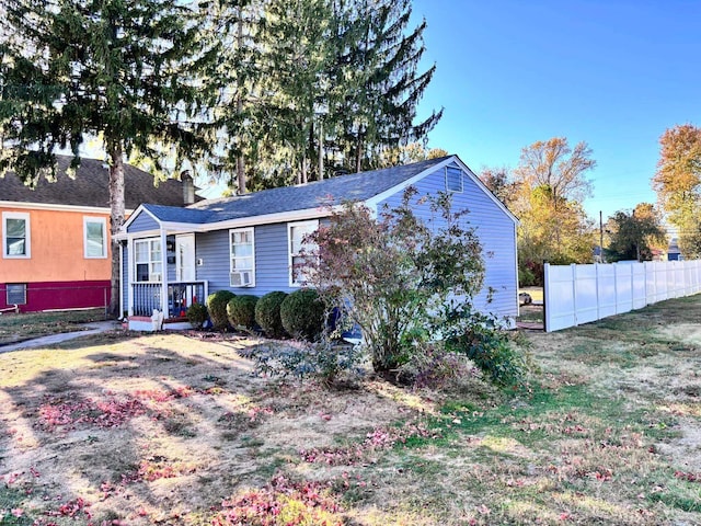 view of front of property with cooling unit and a front yard