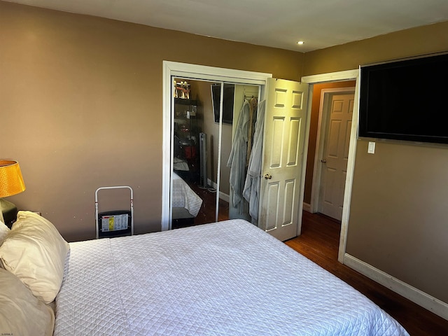 bedroom featuring dark hardwood / wood-style flooring and a closet