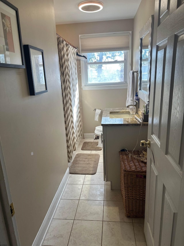 bathroom featuring toilet, vanity, tile patterned flooring, and walk in shower