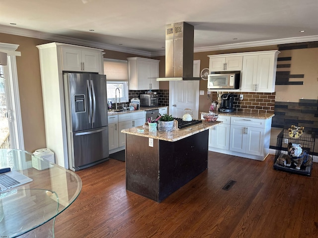 kitchen featuring stainless steel appliances, island exhaust hood, a healthy amount of sunlight, and white cabinets