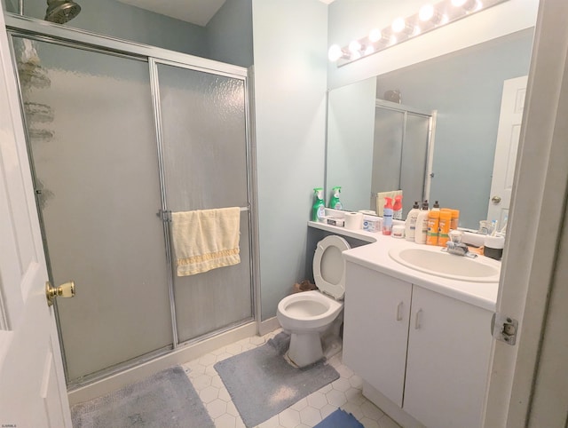 bathroom with tile patterned flooring, vanity, toilet, and walk in shower