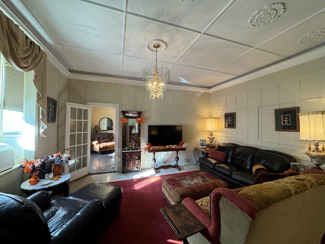 living room with crown molding and a notable chandelier