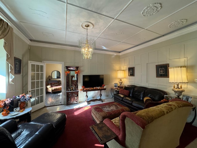 living room with hardwood / wood-style floors, crown molding, and an inviting chandelier