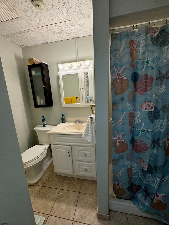 bathroom featuring a shower with curtain, tile patterned flooring, toilet, and vanity