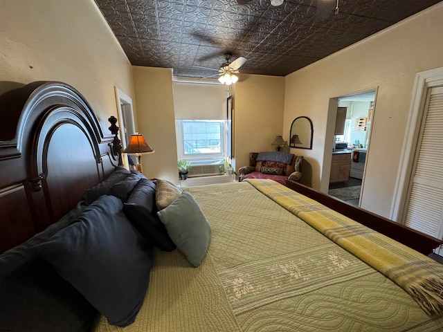 bedroom featuring ceiling fan, connected bathroom, cooling unit, and carpet