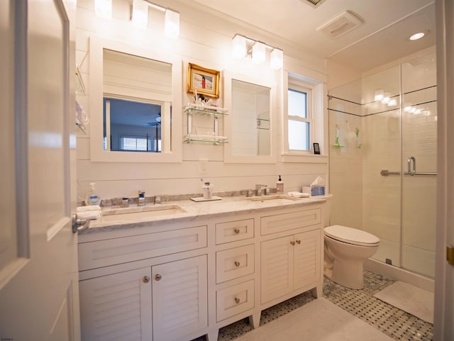 bathroom with crown molding, vanity, toilet, and a shower with door