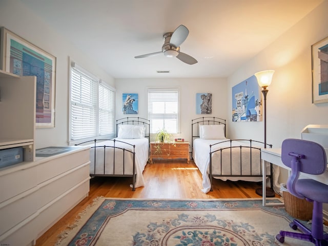 bedroom with ceiling fan and light wood-type flooring