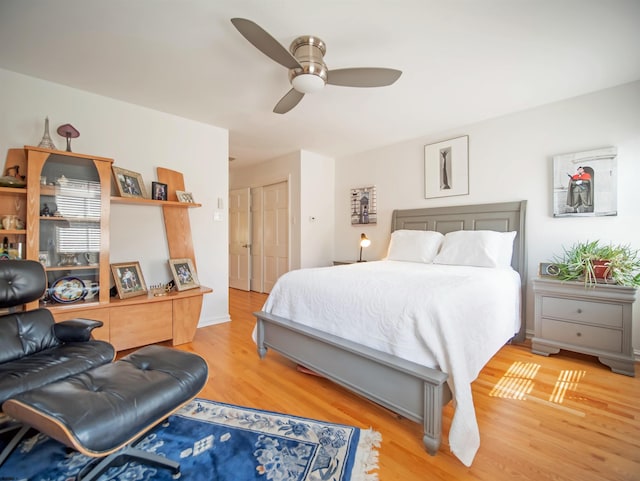 bedroom with a closet, wood-type flooring, and ceiling fan