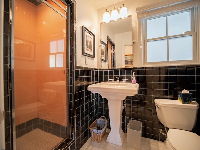 bathroom featuring tile walls, toilet, walk in shower, and tile patterned floors