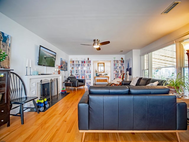 living room with hardwood / wood-style floors and ceiling fan