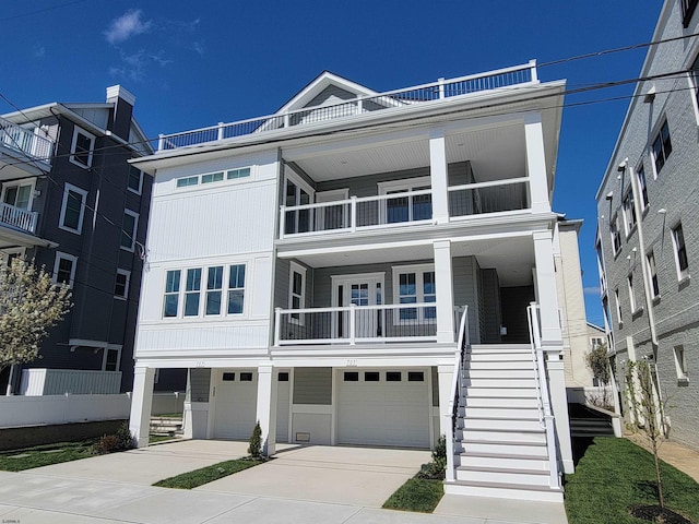705 E 8th St Unit 1, Ocean City, NJ 08226 - view of front of home featuring a garage, driveway, a balcony, and stairway