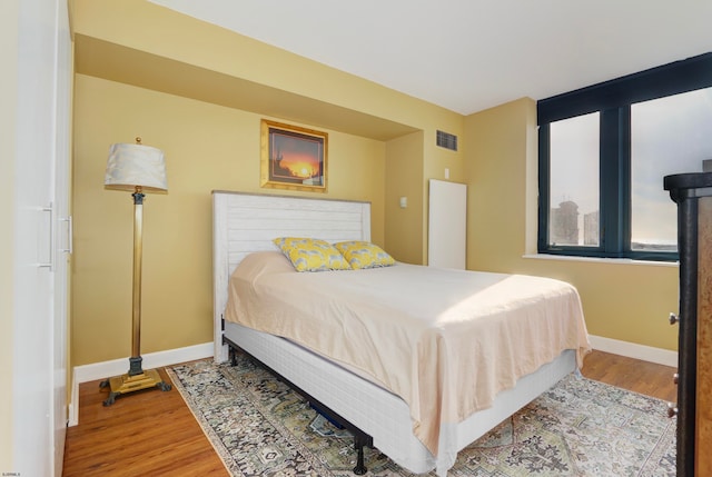 bedroom with hardwood / wood-style floors