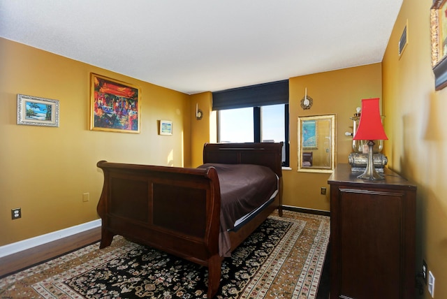 bedroom featuring dark wood-type flooring