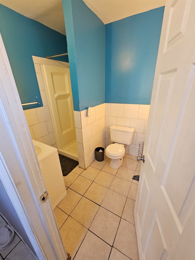 bathroom with walk in shower, tile walls, and tile patterned flooring