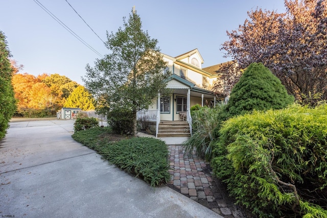 view of front of home with covered porch and an outdoor structure