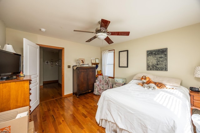 bedroom featuring ceiling fan and dark hardwood / wood-style floors