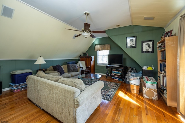 living room with hardwood / wood-style flooring, ceiling fan, and lofted ceiling