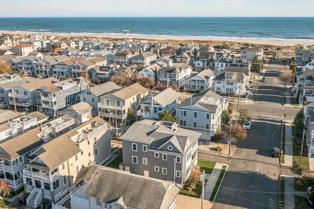 birds eye view of property with a view of the beach and a water view