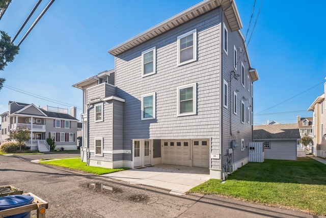 exterior space featuring a garage and a front lawn