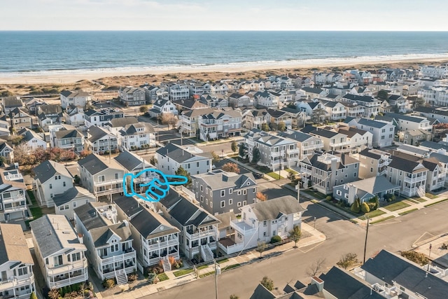 birds eye view of property featuring a view of the beach and a water view