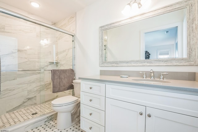 bathroom featuring walk in shower, vanity, tile patterned floors, and toilet