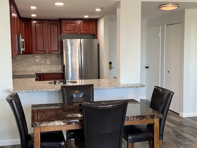 dining room with dark hardwood / wood-style flooring and sink