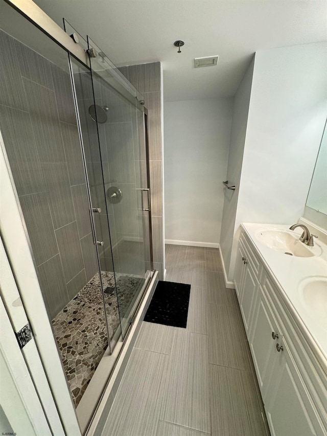 bathroom featuring vanity and a shower with shower door