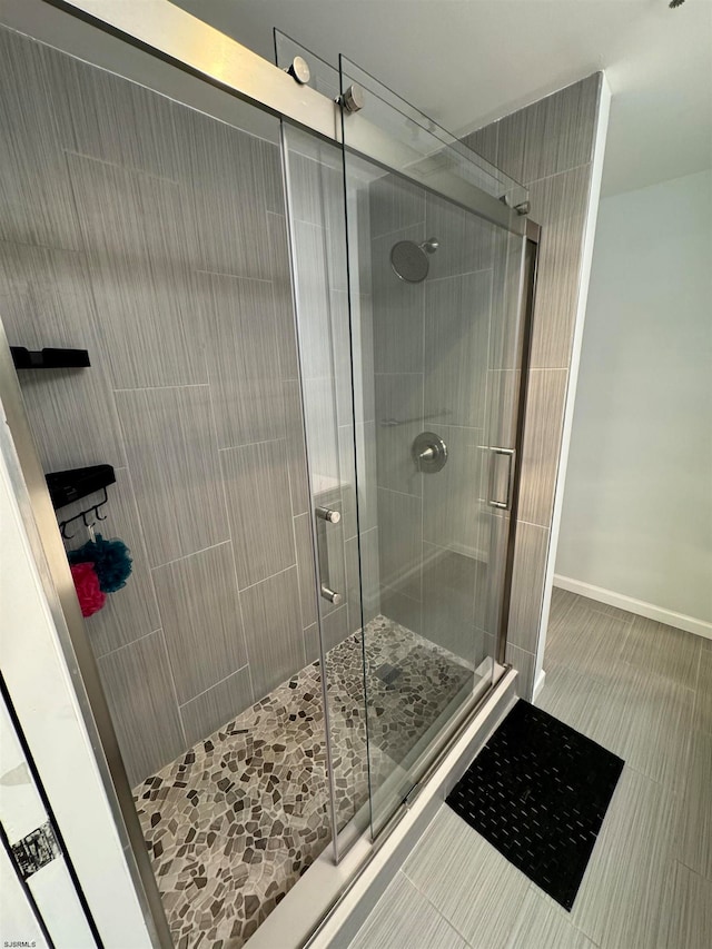 bathroom with a shower with shower door