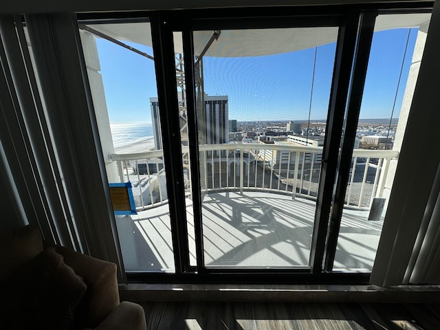 doorway to outside featuring a water view and hardwood / wood-style flooring