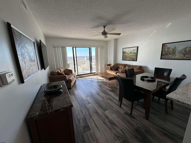 dining room with dark hardwood / wood-style flooring, a textured ceiling, and ceiling fan