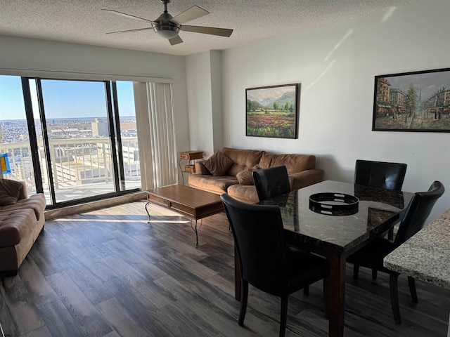 dining room featuring hardwood / wood-style flooring, ceiling fan, and a textured ceiling