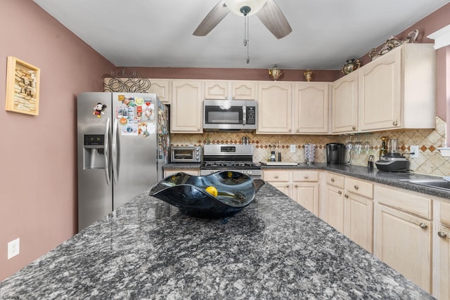 kitchen with decorative backsplash, ceiling fan, and stainless steel appliances