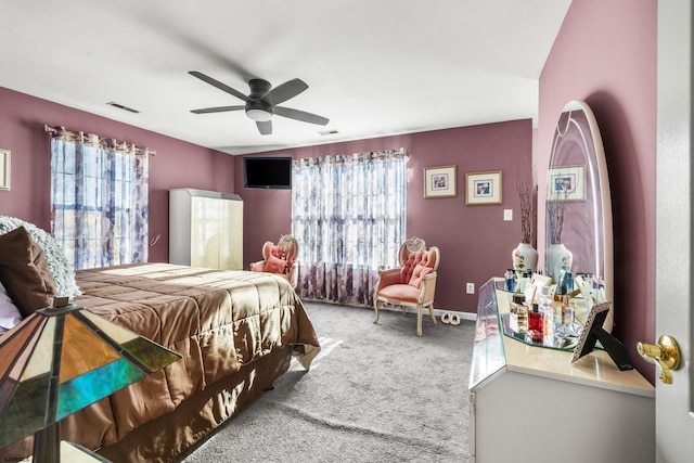 bedroom featuring multiple windows, carpet flooring, and ceiling fan