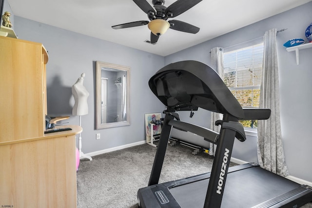 exercise area featuring ceiling fan and dark carpet