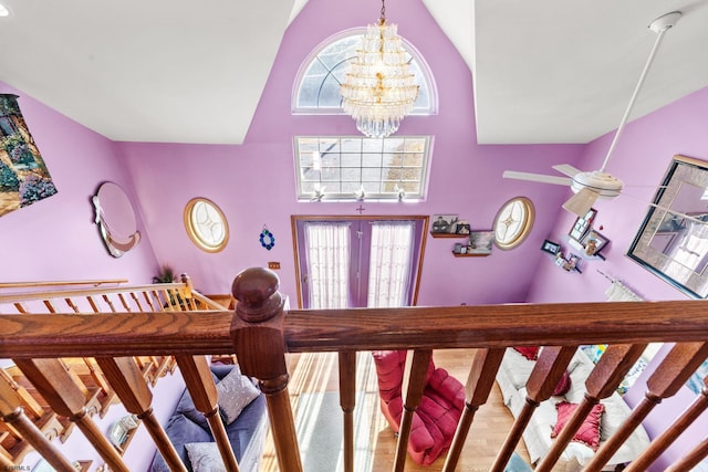 interior space featuring hardwood / wood-style floors, a chandelier, french doors, and high vaulted ceiling