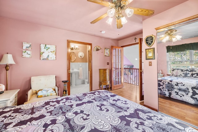 bedroom with light hardwood / wood-style floors, ceiling fan, ensuite bath, and sink