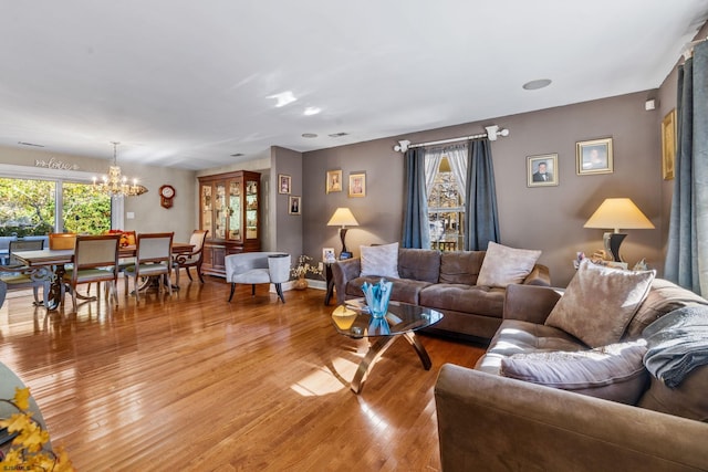 living room featuring hardwood / wood-style floors and an inviting chandelier