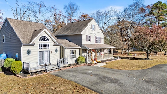 front of property featuring a porch and a front lawn